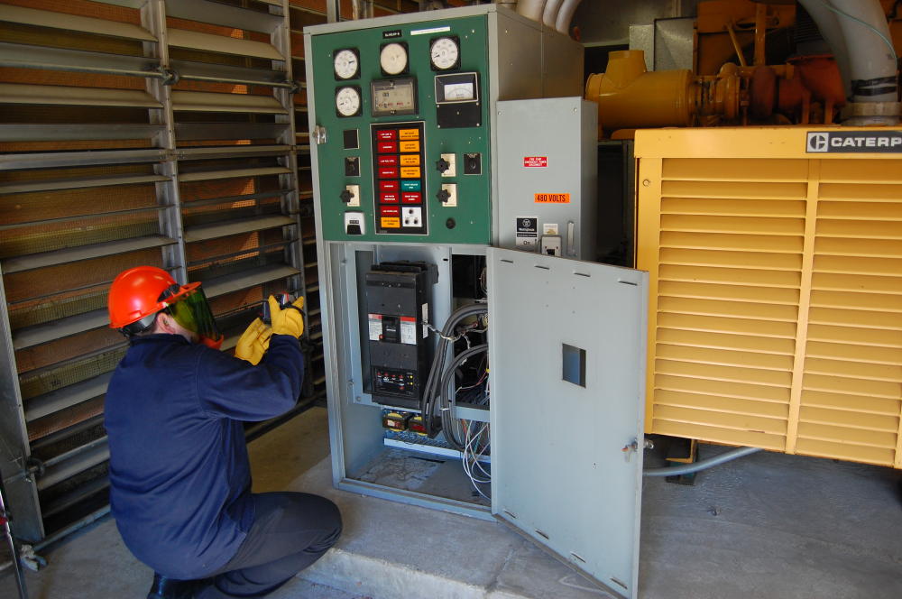Worker checking a fuse box